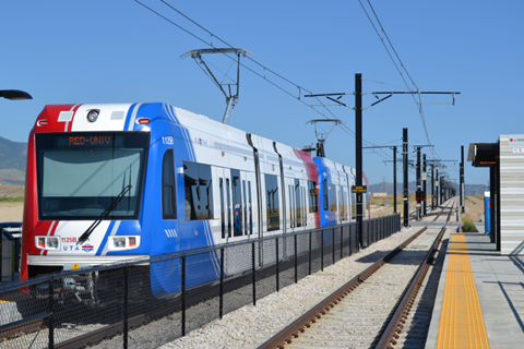 Photo of a UTA trax line stopped at a station.